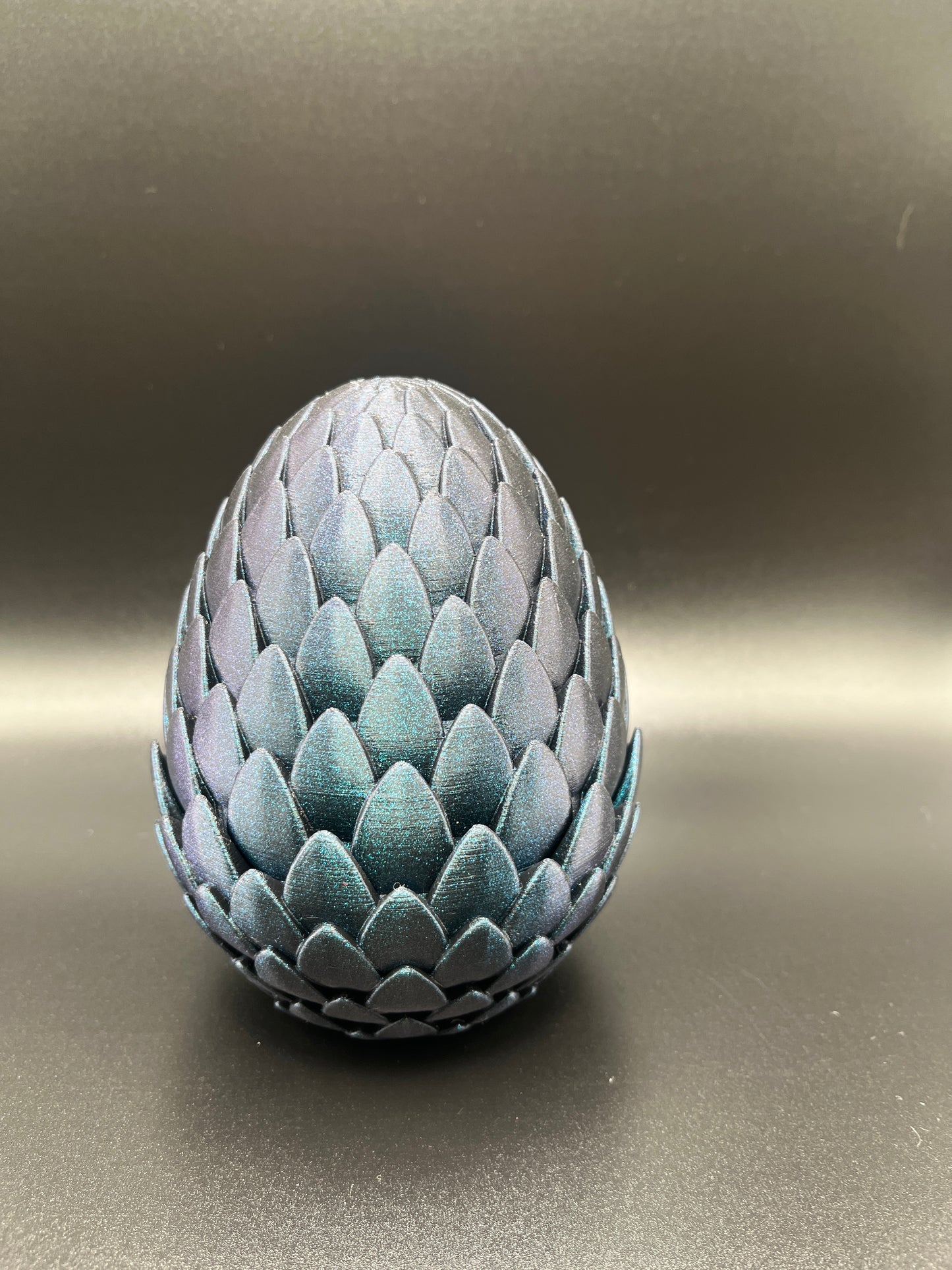 Color change crystal dragon in metallic egg.
