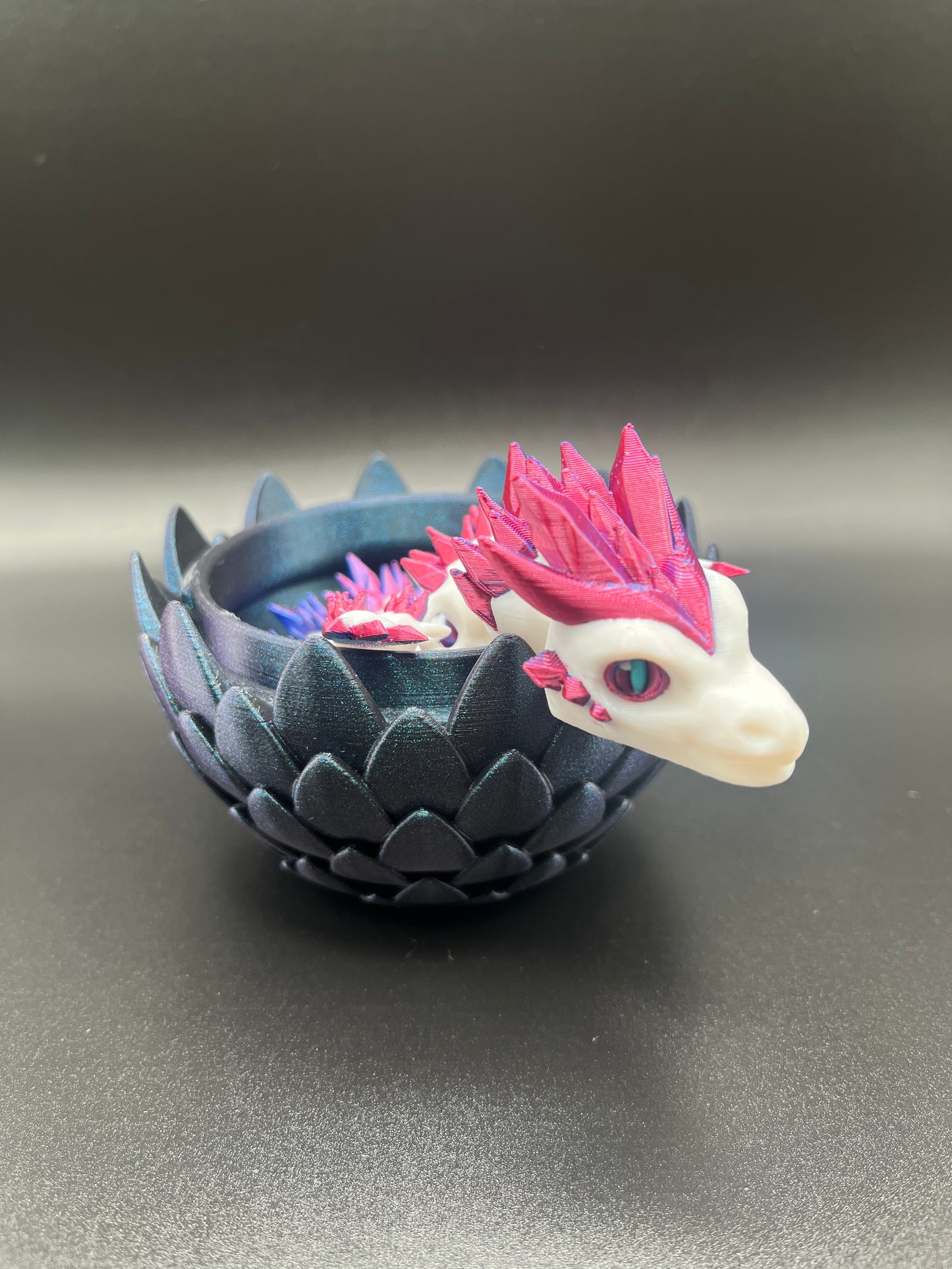 Color change crystal dragon in metallic egg.
